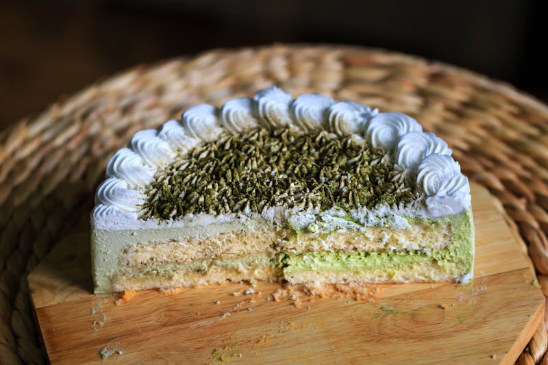 Moist tres leches cake slice with cream topping